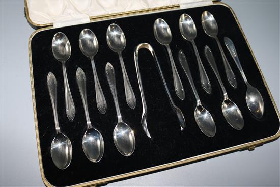 A set of 12 silver coffee spoons and tongs